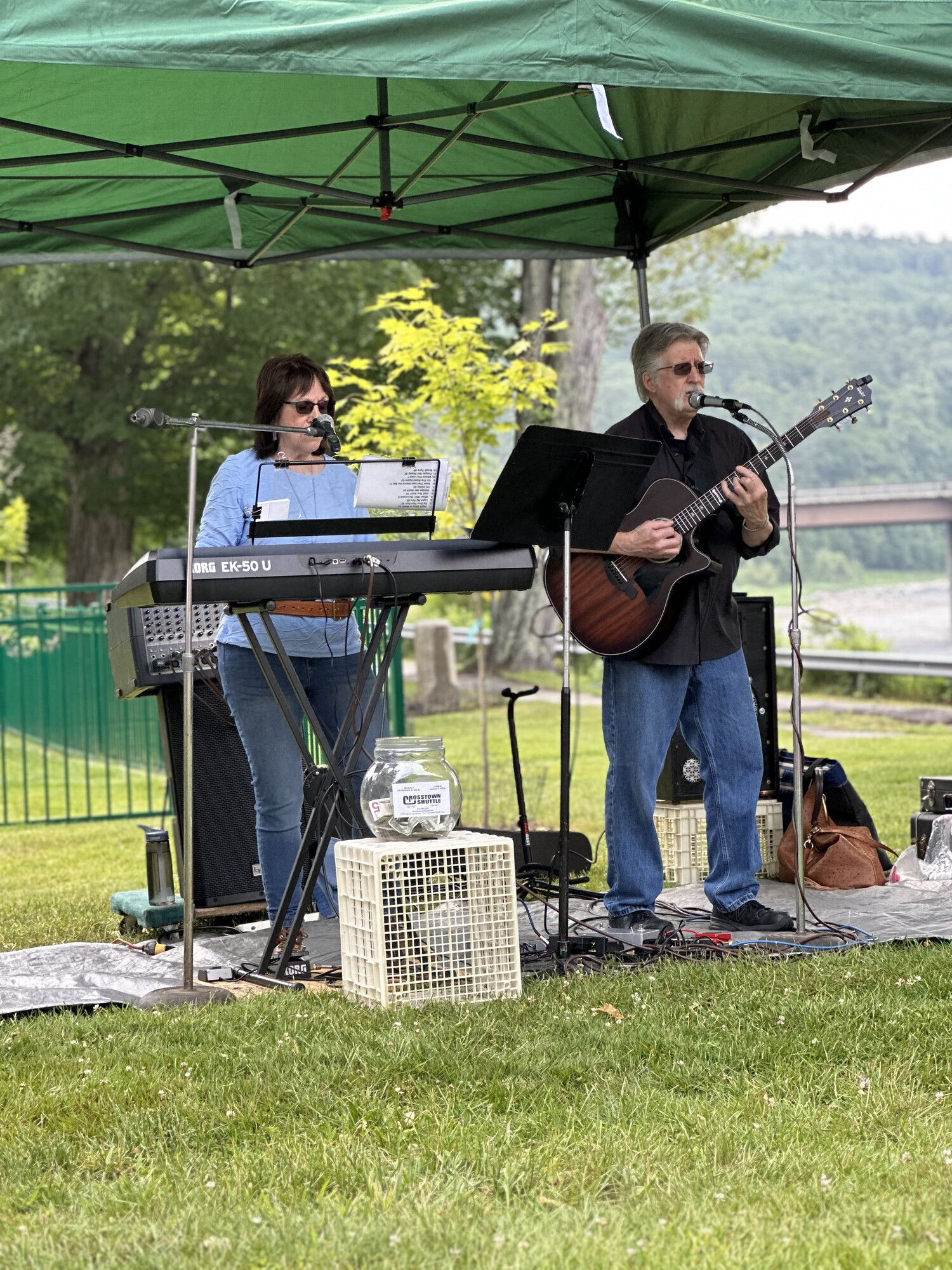 Charlie on acoustic guitar and Beverly at the keys at an outdoor park show